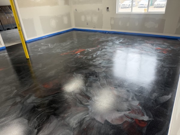 High-gloss black and red metallic epoxy floor in a commercial room