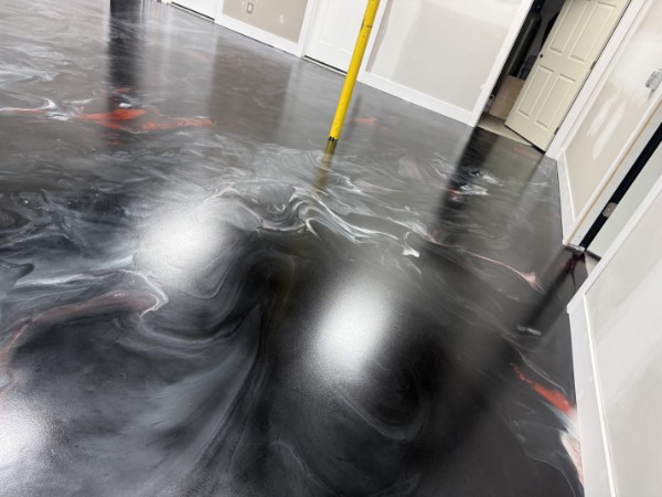 Black metallic epoxy floor with silver and red marbling