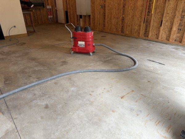 Diamond grinding and HEPA vacuuming during garage prep