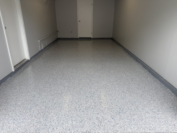 Gray and white flake epoxy garage floor with cove base