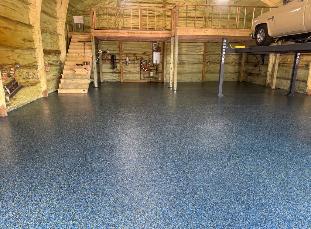 Blue flake epoxy pole barn floor with vehicle lift